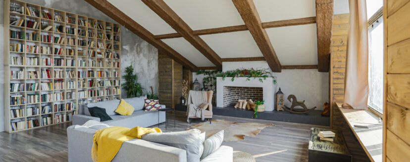 Dark loft style interior of big cozy country house. open plan apartment with kitchen area, rest zone and bed area. Huge windows and wooden decoration
